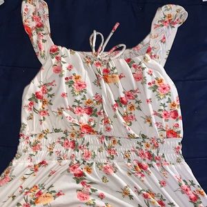 A pretty white floral print dress w/ breast padded top. Low cut dress.